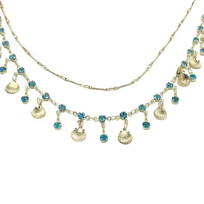 Daughter Of The Sea Blue Zircon Gold Shell Niche Necklaces