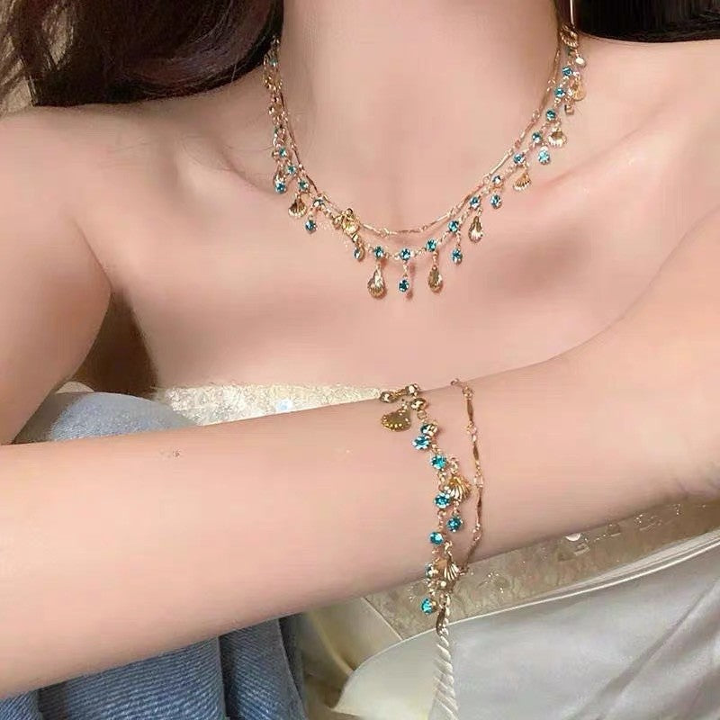 Daughter Of The Sea Blue Zircon Gold Shell Niche Necklaces